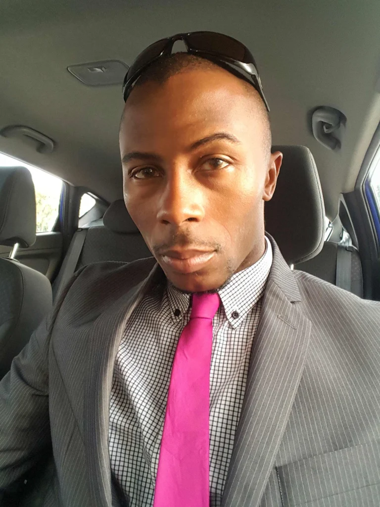 Az Respes wearing a grey suit and pink tie going over Discipline Over Motivation: 5 Step System to Outwork Prejudice