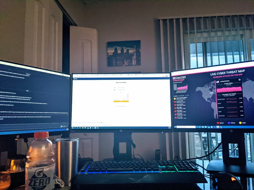 triple monitor setup featuring ahrefs